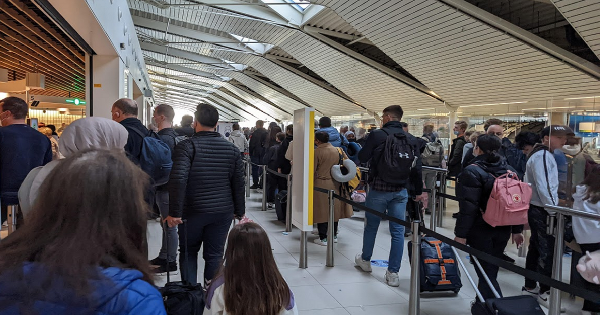 Passengers queue for security check at Amsterdam April 2022